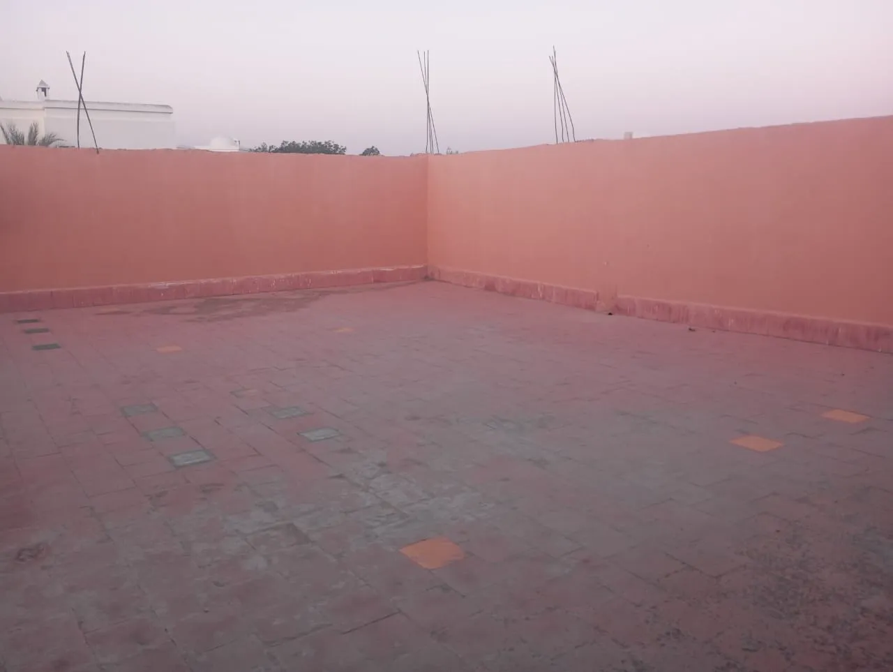 House exterior with parking and green surroundings