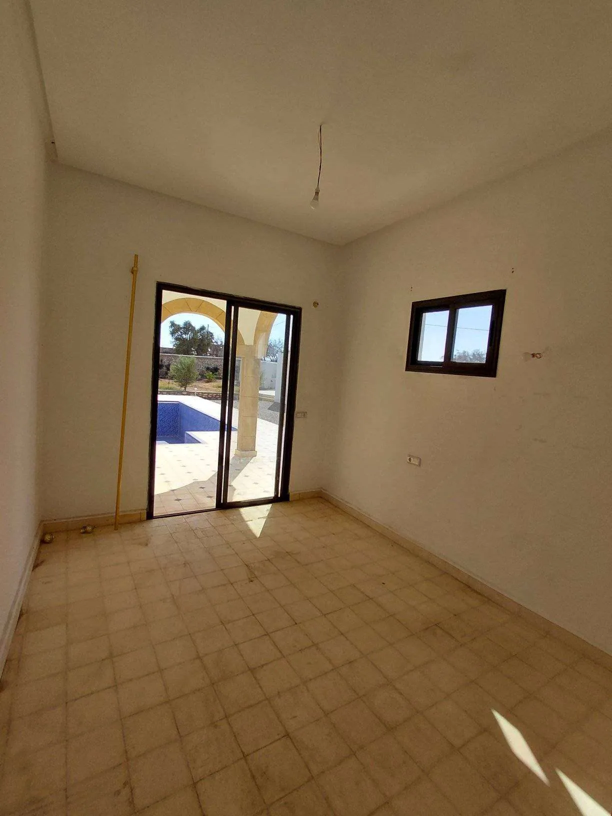 Poolside area surrounded by greenery