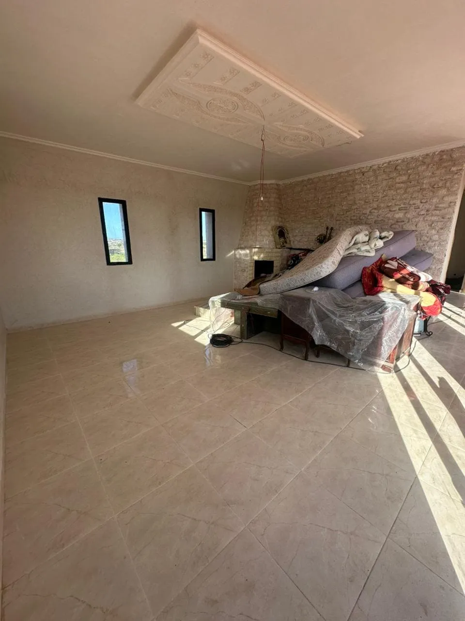 Spacious living room with fireplace in villa