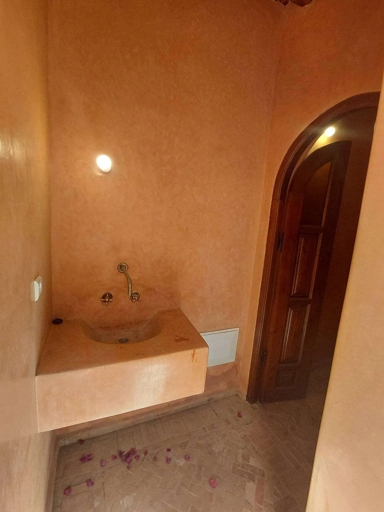 Sunlit villa exterior with garden and pool