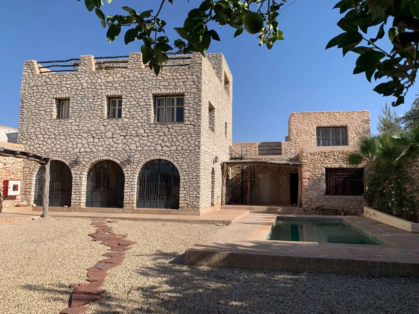 Overall view of the property combining villa, bungalow, and pool area