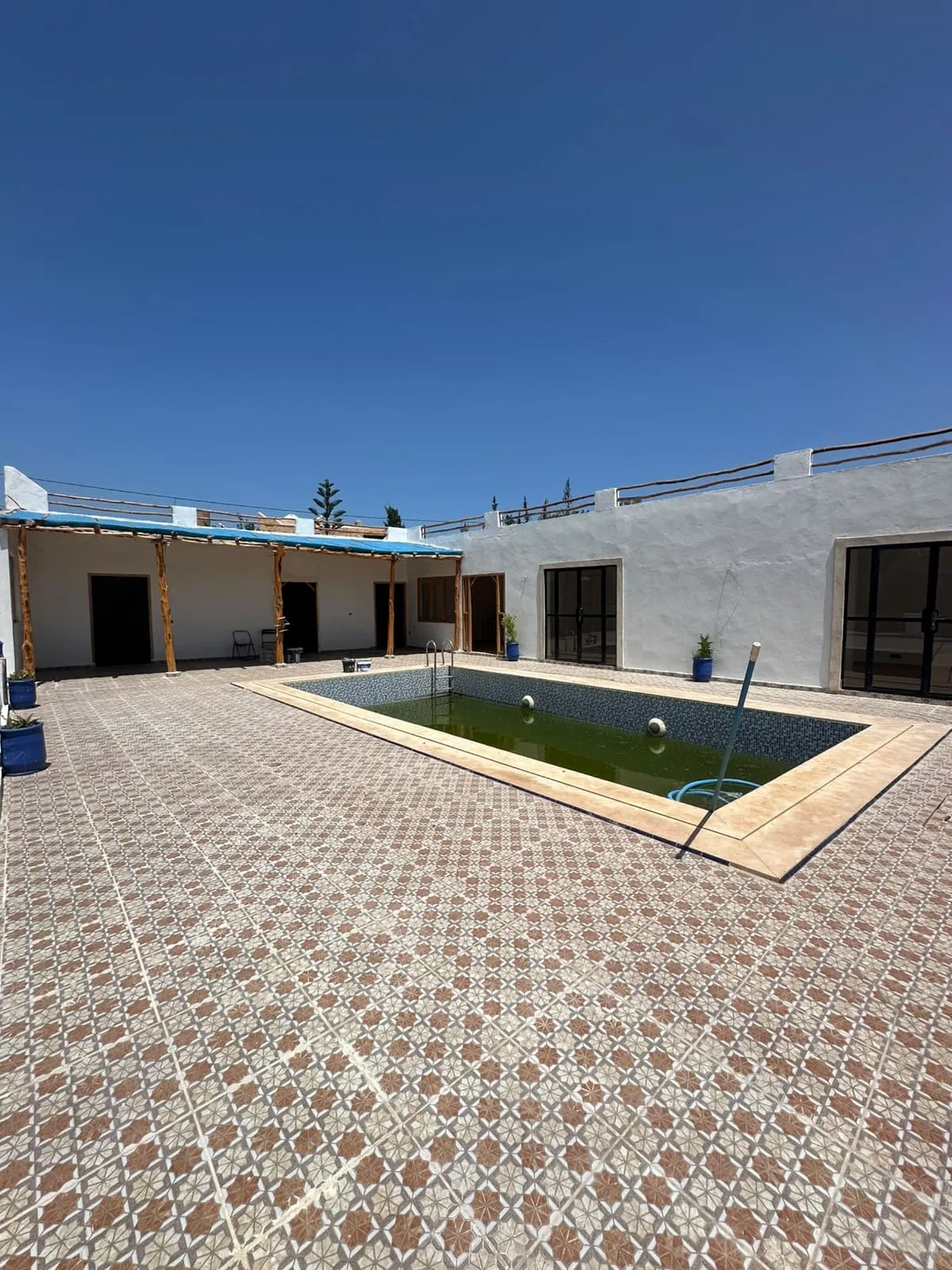 Private swimming pool with sunbathing area
