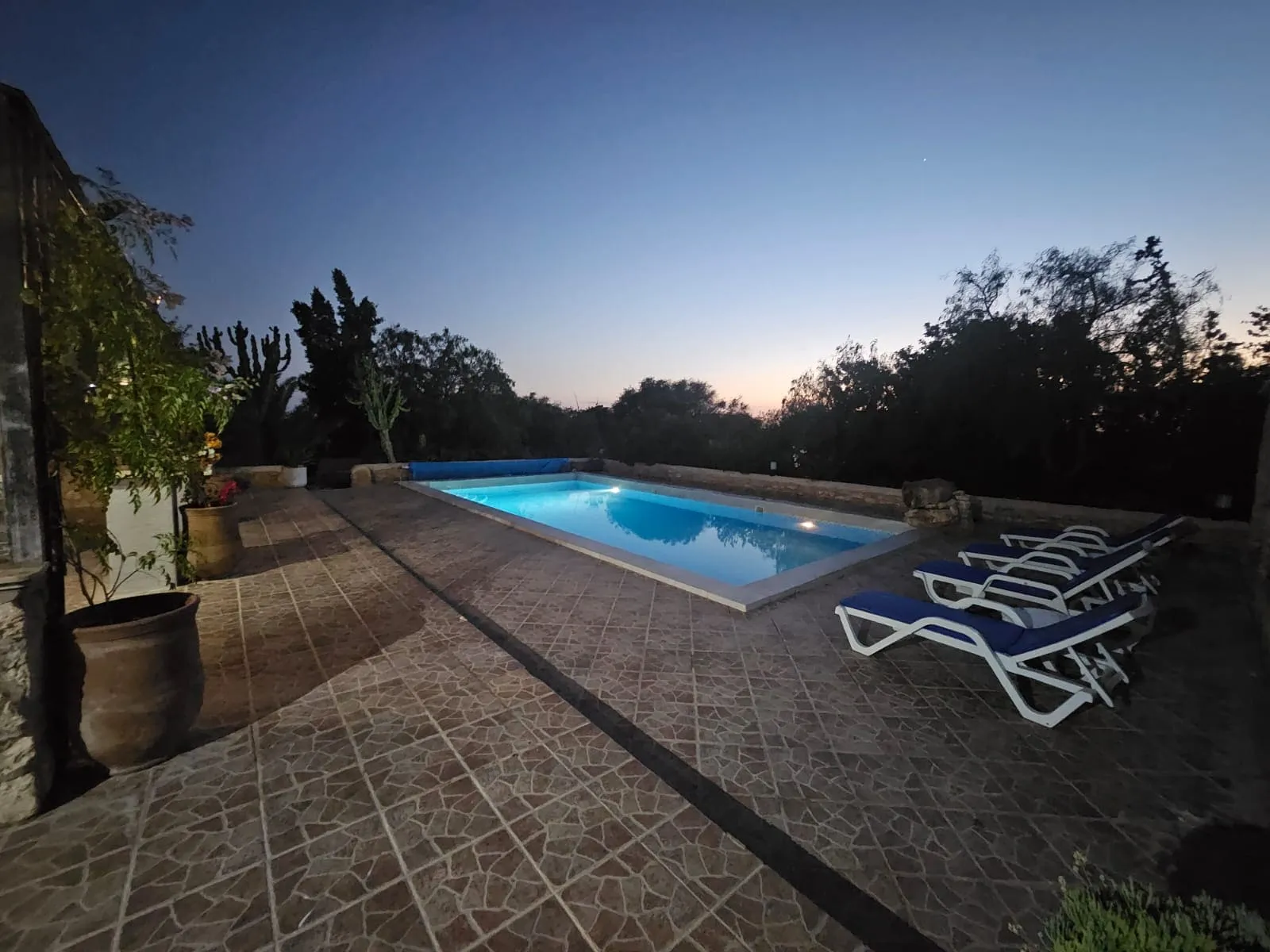 Large outdoor swimming pool beside stone villa near Essaouira