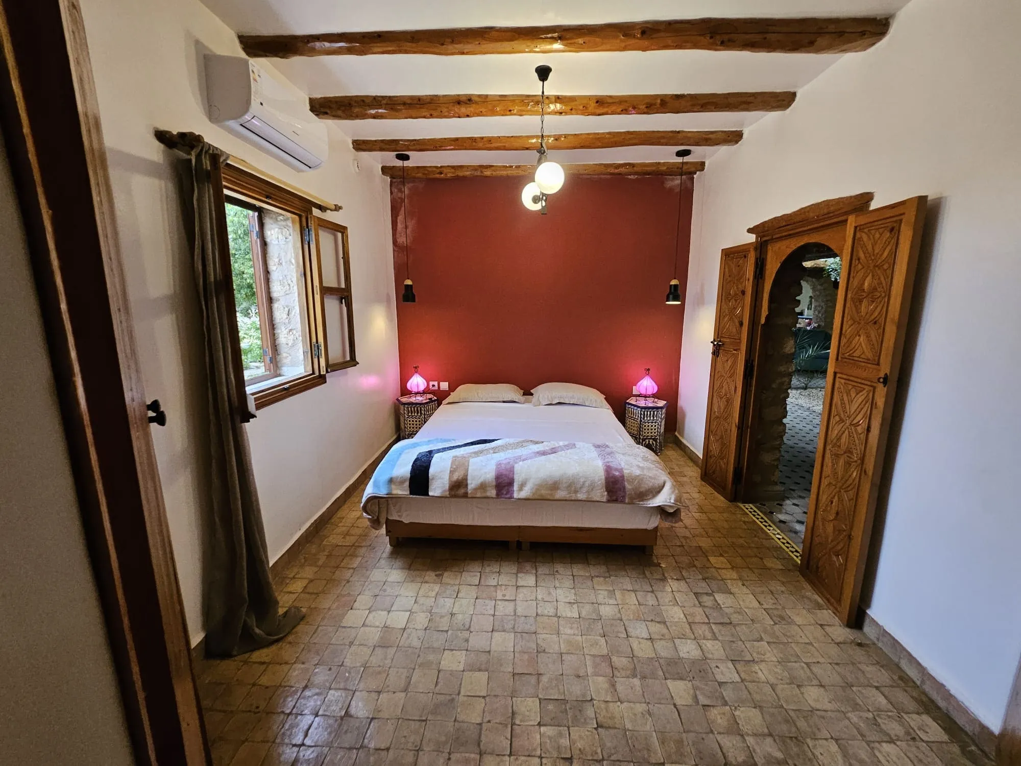 Spacious bedroom suite with natural stone details near Essaouira